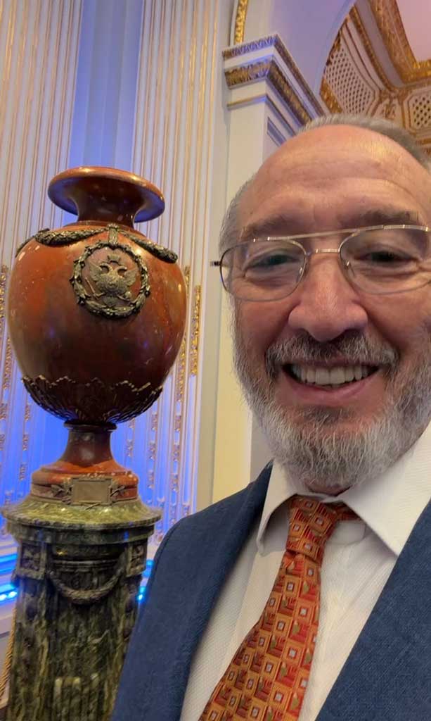 Frederick Ravid beside an ornate Fabergé urn displayed in the New York Stock Exchange Board Room.
